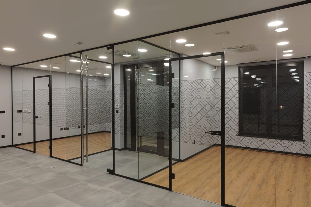 Exposed ceiling office interior showing ductwork and lighting
